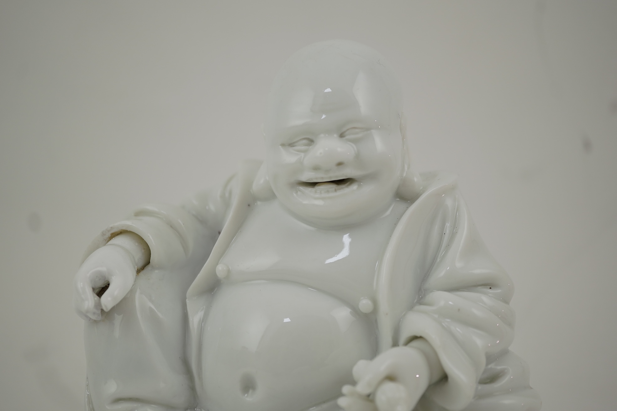 A Chinese blanc-de-chine seated figure of Budai, 18th/19th century